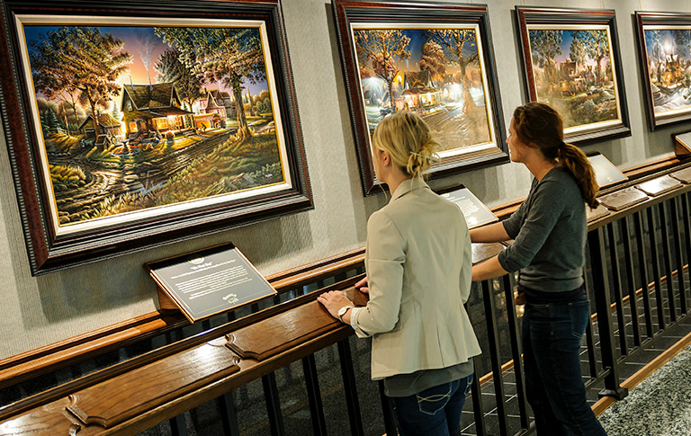 people looking at paintings