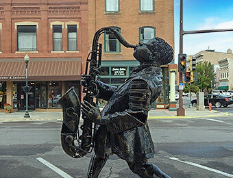 statue of a man play the saxophone