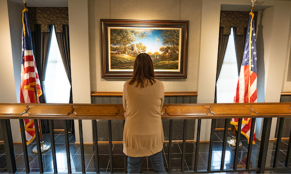 woman looking at painting